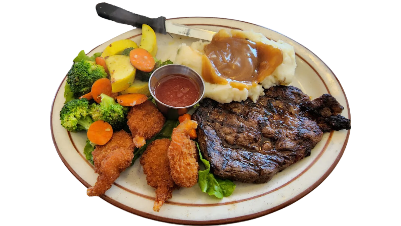 Steak and shrimp dinner with vegetables and mashed potatoes